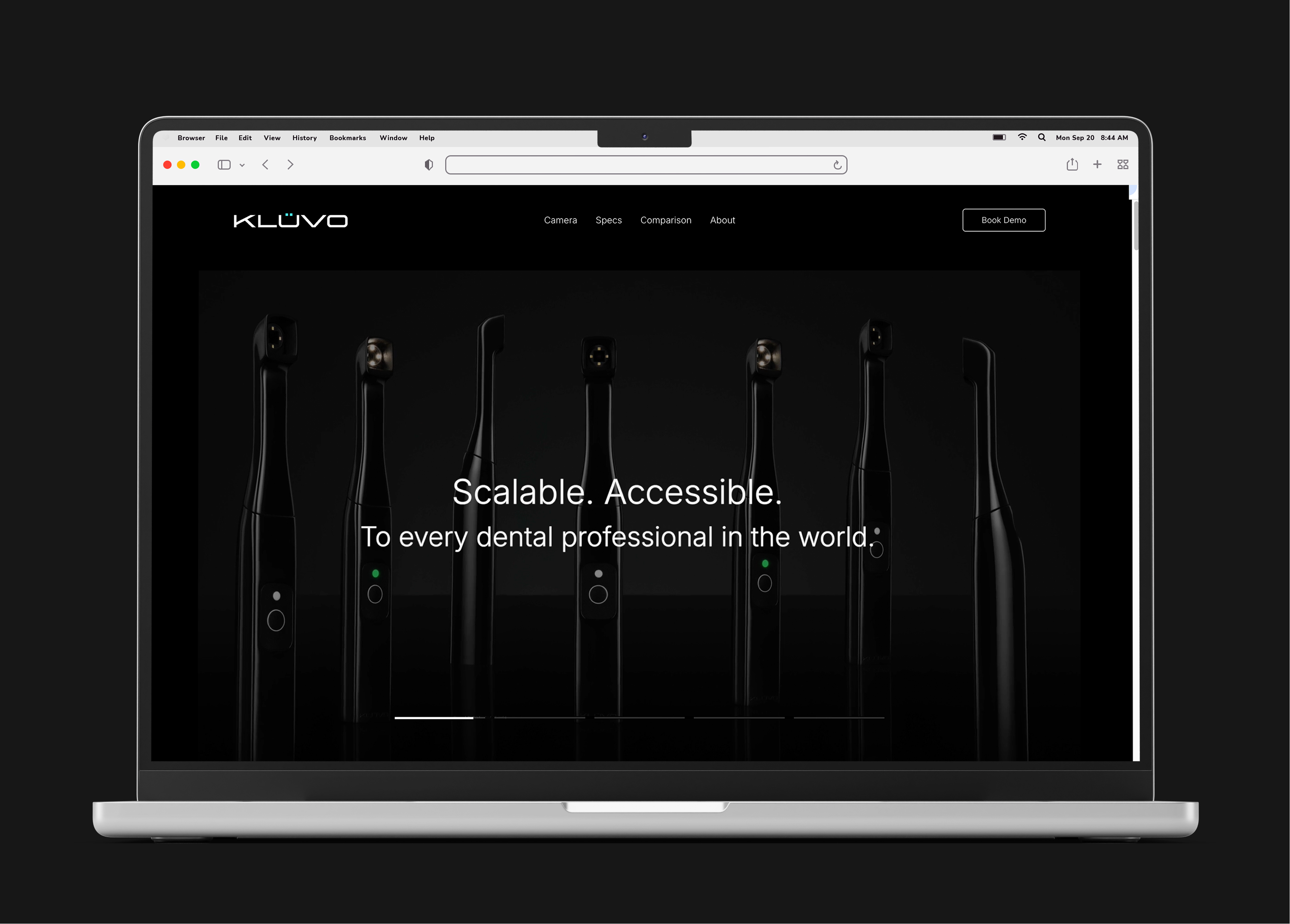 kluvo.com on a laptop: a dark homepage of standing devices under the headline “Scalable. Accessible. To every dental professional in the world.”